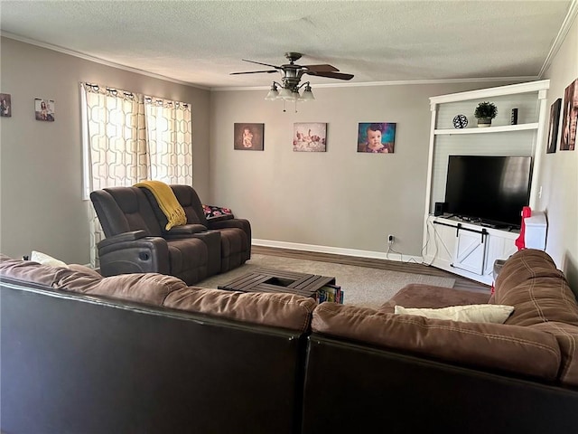 carpeted living room with ceiling fan, a textured ceiling, and ornamental molding