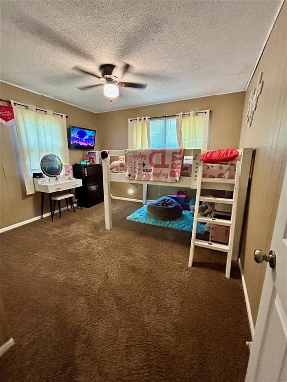 carpeted bedroom featuring ceiling fan and a textured ceiling