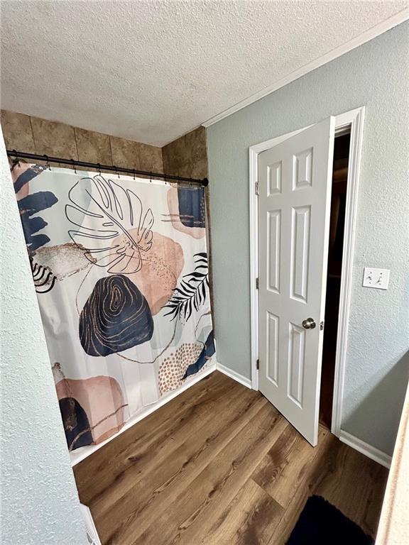 interior space with hardwood / wood-style floors and a textured ceiling