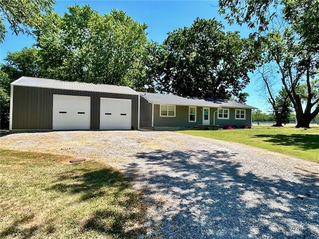 ranch-style house with a garage, an outdoor structure, and a front lawn