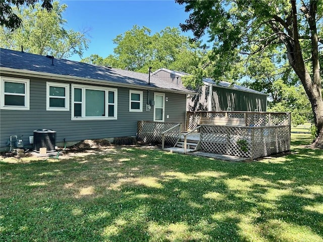 back of property featuring a deck, a yard, and central air condition unit