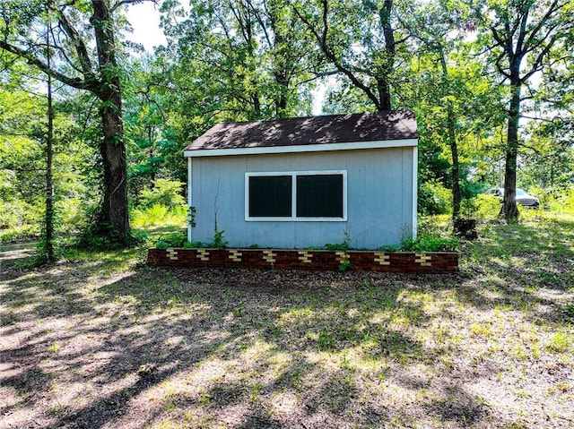 view of side of home featuring a storage unit