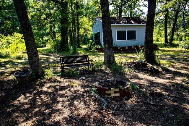 view of yard with a fire pit