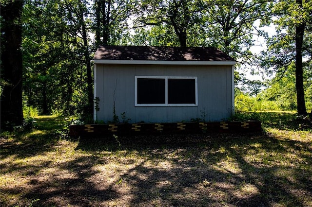 view of side of home featuring a storage shed