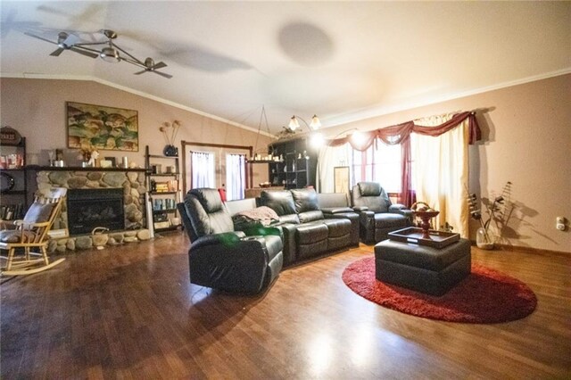 living room featuring ceiling fan, crown molding, a stone fireplace, wood-type flooring, and lofted ceiling