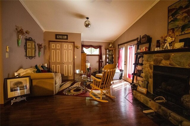 living room with ornamental molding, a fireplace, wood-type flooring, and vaulted ceiling