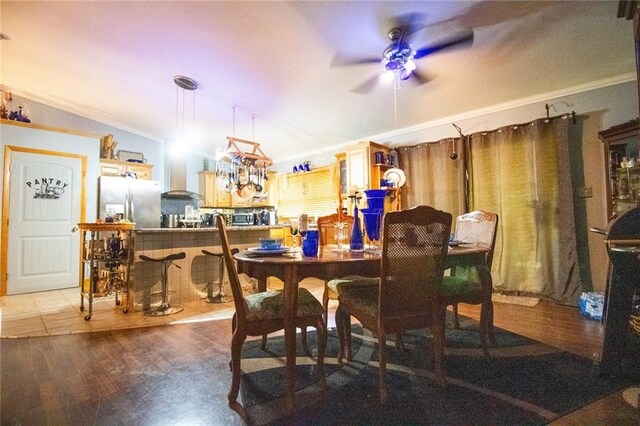 dining area with wood-type flooring, ceiling fan, and crown molding