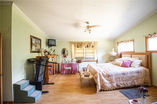 bedroom with crown molding, ceiling fan, and hardwood / wood-style floors