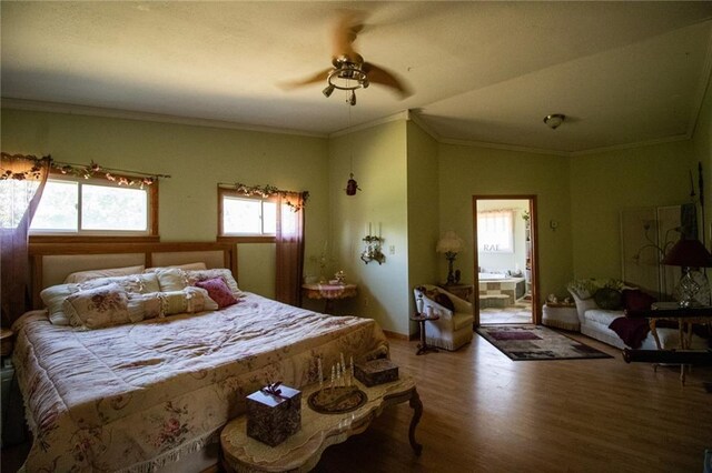 bedroom featuring crown molding, wood-type flooring, ceiling fan, and ensuite bath