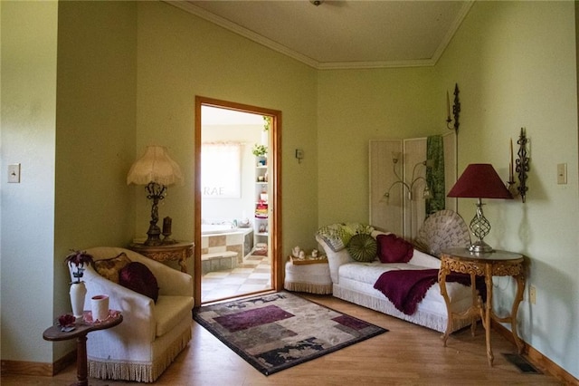 sitting room featuring hardwood / wood-style floors and crown molding