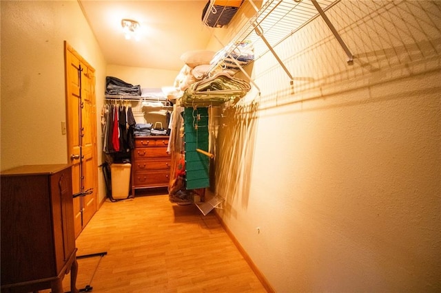 walk in closet featuring light hardwood / wood-style floors