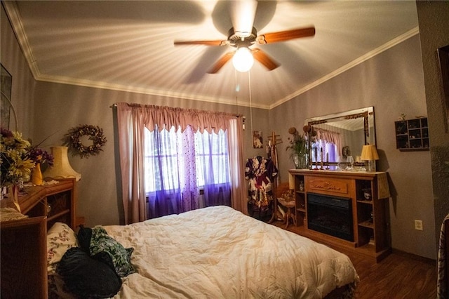 bedroom featuring ceiling fan, ornamental molding, and wood-type flooring