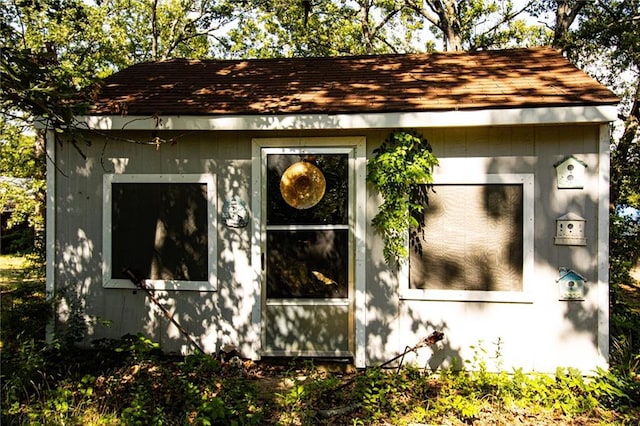 view of side of home with an outdoor structure