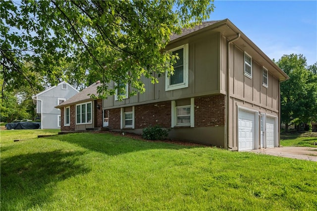 split level home with a front lawn and a garage