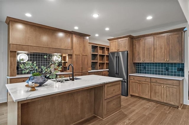 8736 N Lewis Ave, Kansas City, MO 64157 - kitchen with freestanding refrigerator, a sink, wood finished floors, recessed lighting, and backsplash