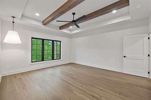 8736 N Lewis Ave, Kansas City, MO 64157 - spare room featuring a ceiling fan, wood finished floors, baseboards, beam ceiling, and a tray ceiling