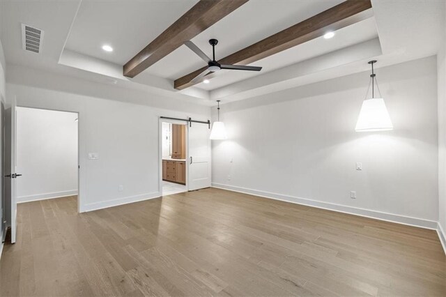 8736 N Lewis Ave, Kansas City, MO 64157 - empty room with baseboards, a ceiling fan, a barn door, wood finished floors, and beam ceiling