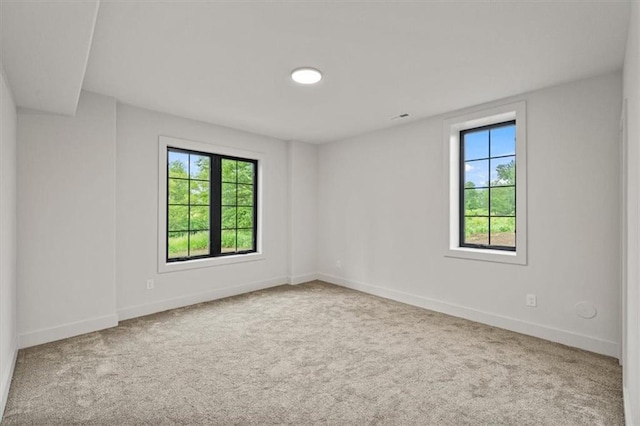 8736 N Lewis Ave, Kansas City, MO 64157 - empty room with healthy amount of natural light, carpet, and baseboards