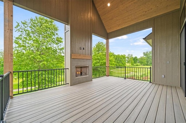 8736 N Lewis Ave, Kansas City, MO 64157 - wooden deck with view of wooded area and exterior fireplace