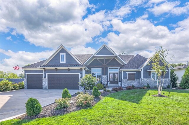 craftsman inspired home featuring a garage and a front yard