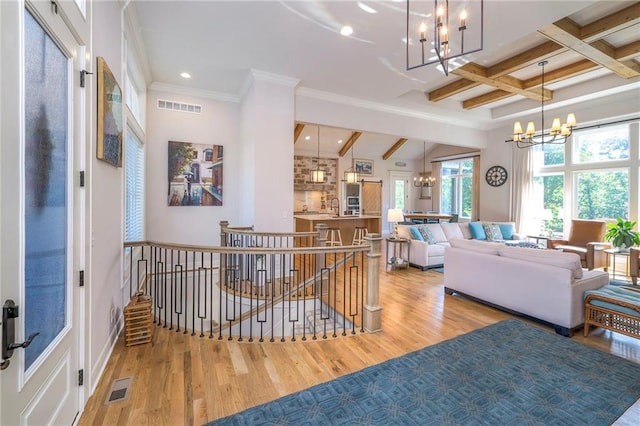 interior space featuring beamed ceiling, a notable chandelier, coffered ceiling, and light wood-type flooring