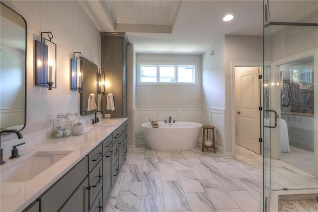 bathroom featuring a tub, tile patterned floors, double sink vanity, and crown molding