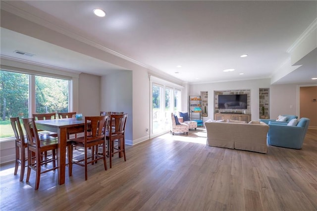 dining area featuring crown molding and hardwood / wood-style floors