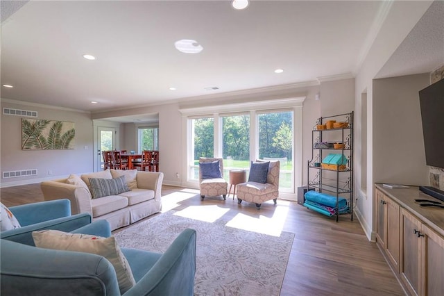 living room featuring wood-type flooring and ornamental molding