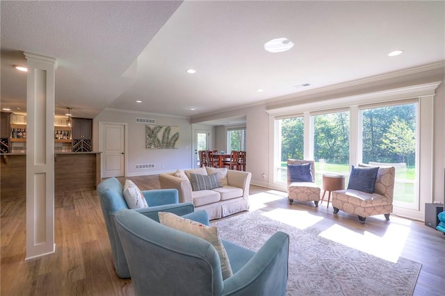 living room featuring a wealth of natural light and hardwood / wood-style flooring