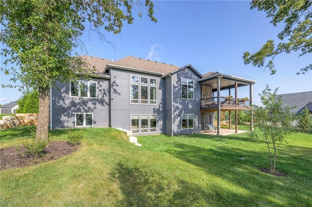 rear view of house with a patio area and a lawn