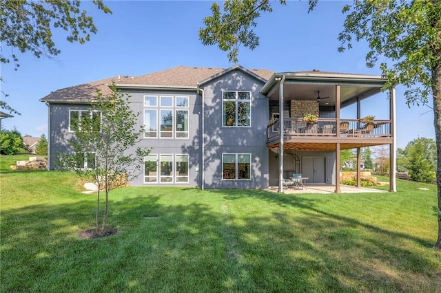 rear view of property with a patio, a lawn, and ceiling fan