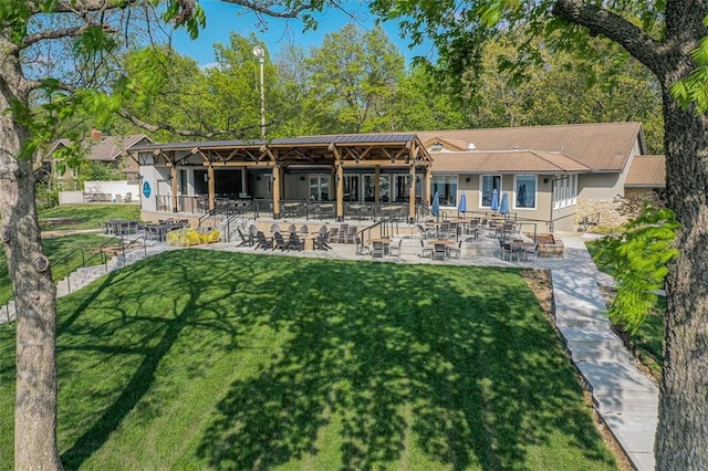 rear view of house featuring a patio and a yard