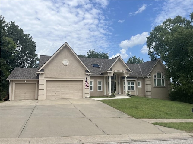 view of front of house with a garage and a front lawn