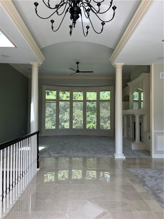 empty room with ornate columns and plenty of natural light