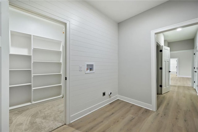 laundry room featuring laundry area, hookup for a washing machine, baseboards, and wood finished floors