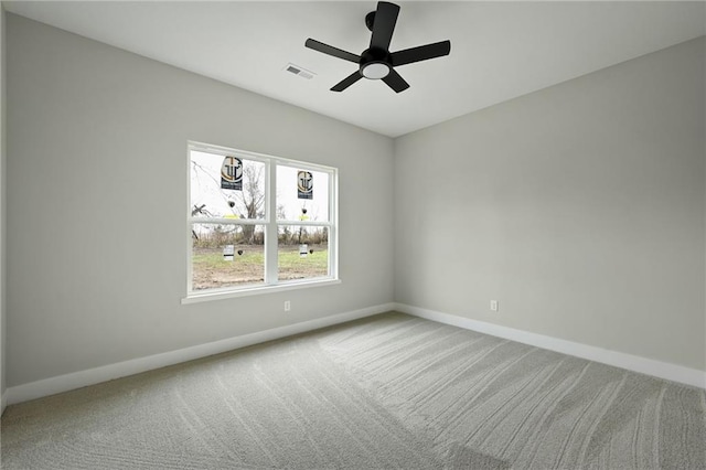 spare room featuring visible vents, carpet floors, baseboards, and ceiling fan