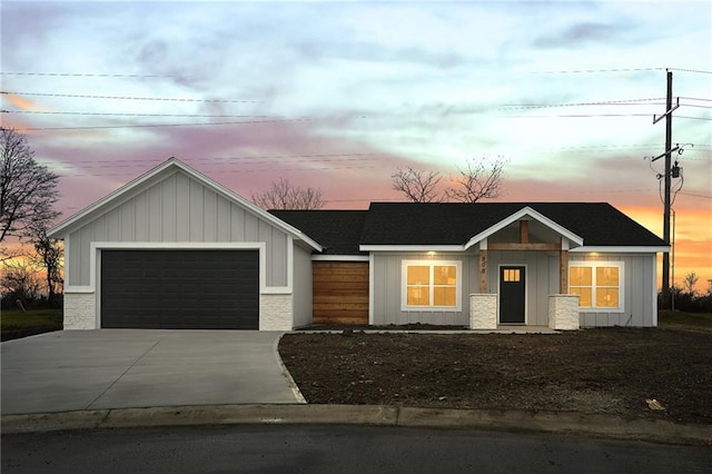 view of front of house with board and batten siding, concrete driveway, and a garage