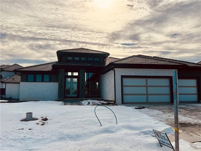 prairie-style home featuring a garage