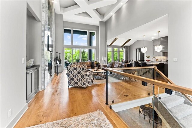 6101 NW 58th St, Kansas City, MO 64151 - living area featuring light wood-style flooring, beamed ceiling, and coffered ceiling
