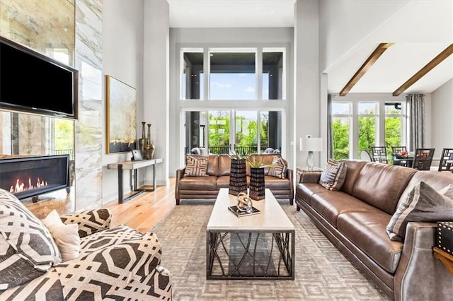 6101 NW 58th St, Kansas City, MO 64151 - living area with a high ceiling, a fireplace, and wood finished floors