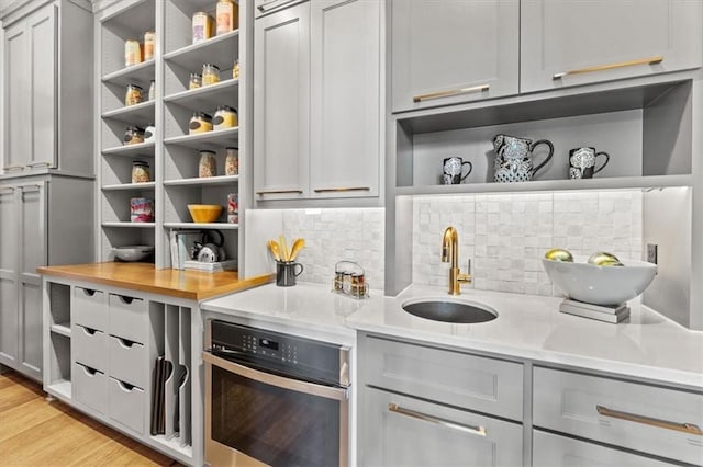 6101 NW 58th St, Kansas City, MO 64151 - indoor wet bar with oven, tasteful backsplash, and light wood-style flooring