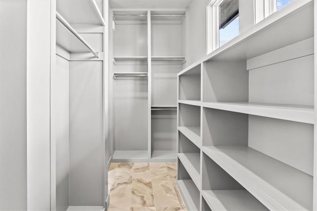 6101 NW 58th St, Kansas City, MO 64151 - walk in closet with marble look tile flooring