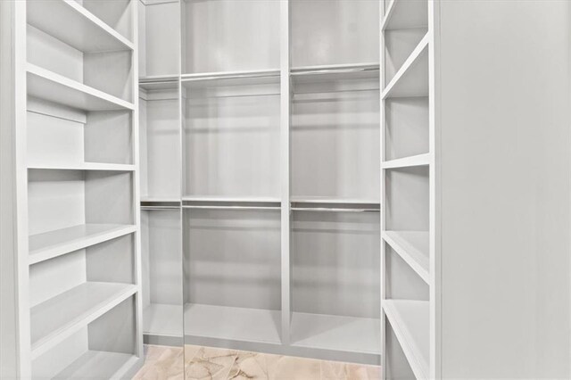 6101 NW 58th St, Kansas City, MO 64151 - walk in closet featuring marble look tile flooring