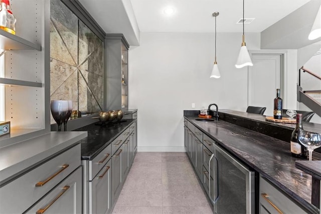 6101 NW 58th St, Kansas City, MO 64151 - bar with beverage cooler, baseboards, a sink, hanging light fixtures, and light tile patterned flooring