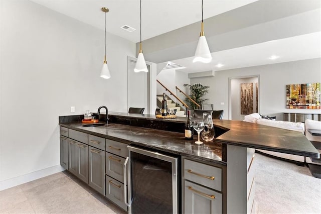 6101 NW 58th St, Kansas City, MO 64151 - bar area featuring wine cooler, a sink, pendant lighting, baseboards, and stairway