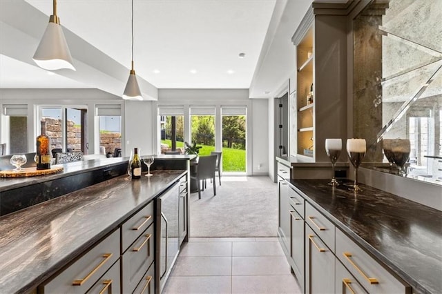 6101 NW 58th St, Kansas City, MO 64151 - kitchen with light carpet, light tile patterned flooring, decorative light fixtures, dark stone counters, and wine cooler