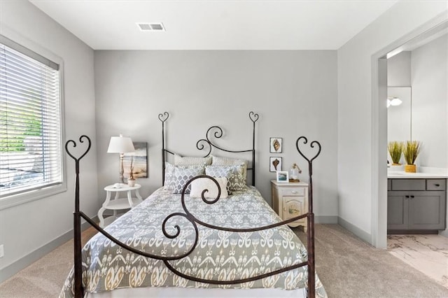6101 NW 58th St, Kansas City, MO 64151 - bedroom with light colored carpet, baseboards, and connected bathroom