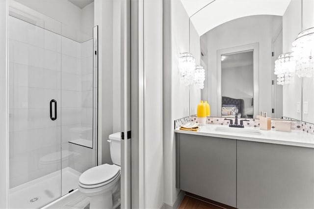 6101 NW 58th St, Kansas City, MO 64151 - ensuite bathroom featuring toilet, a stall shower, vanity, and wood finished floors