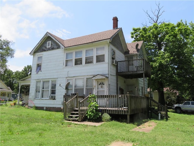 view of front of house with a wooden deck and a front lawn