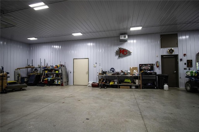 garage with wooden walls and a workshop area